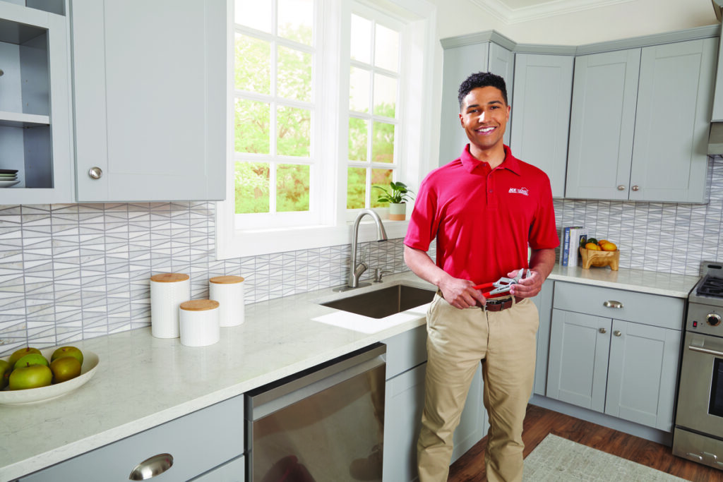 Plumber in front of a kitchen sink